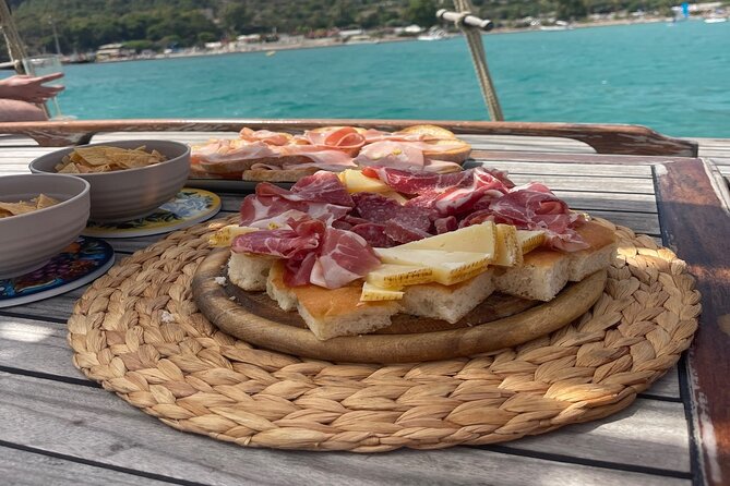Cagliari Gulf Boat tour : 5 stops, snorkeling & local aperitif - Stop 4: Sella del Diavolo stacks, natural pools, and a dramatic cliff