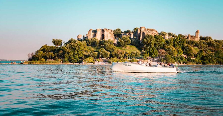 Desenzano del Garda: Sunset Boat Trip at Sunset with Drink - The Sirmione views you get from the water at sunset