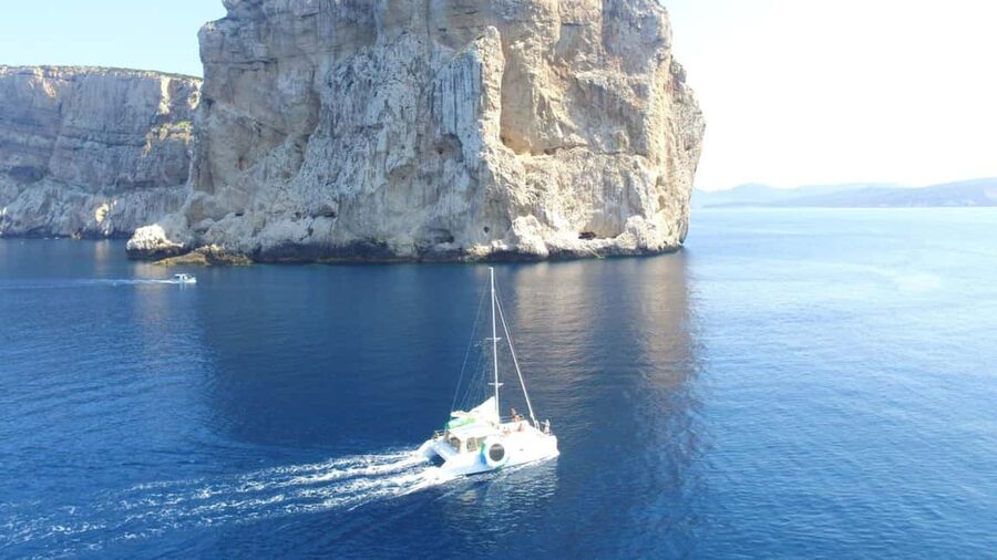 Porto Conte: Half-day catamaran tour with aperitif - Sailing toward Capo Caccia: the coast view you came for