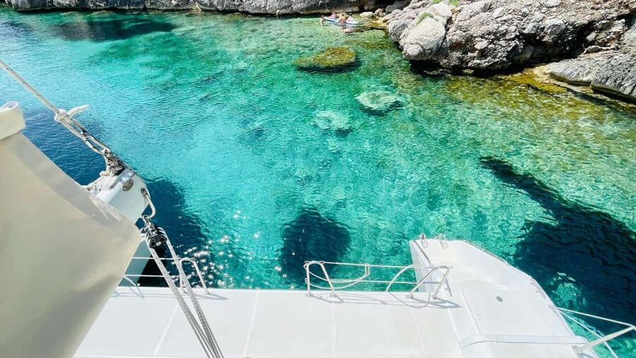 Porto Conte: Half-day catamaran tour with aperitif - The aperitif spread: local cheese and wine that feel earned