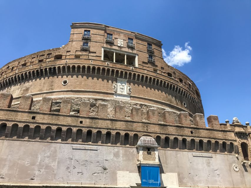 Rome: Castel Sant'Angelo Skip-the-Line Ticket - Redeeming your voucher at the orange umbrella, red jacket meet point