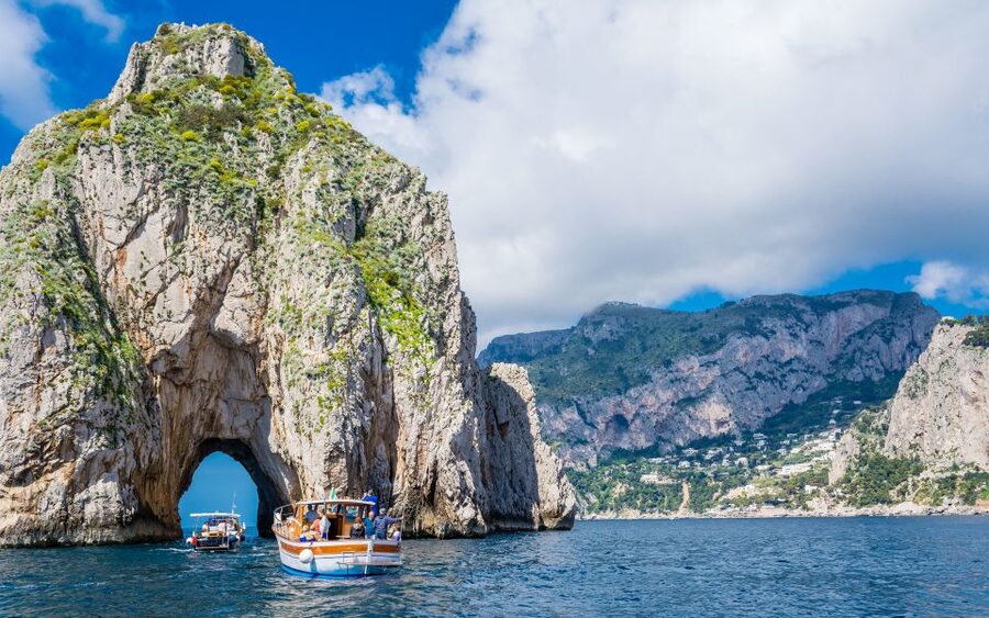 Sorrento: Capri and Blue Grotto Boat Cruise with Drinks - Capri coast icons from the water: Faraglioni, Natural Arch, and Punta Carena
