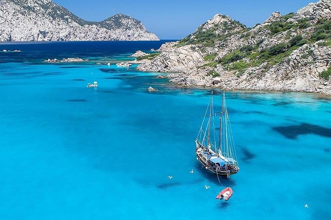 Tavolara Boat Tour and Snorkeling - The ride out: Capo Cesareo coastline views before the big blue